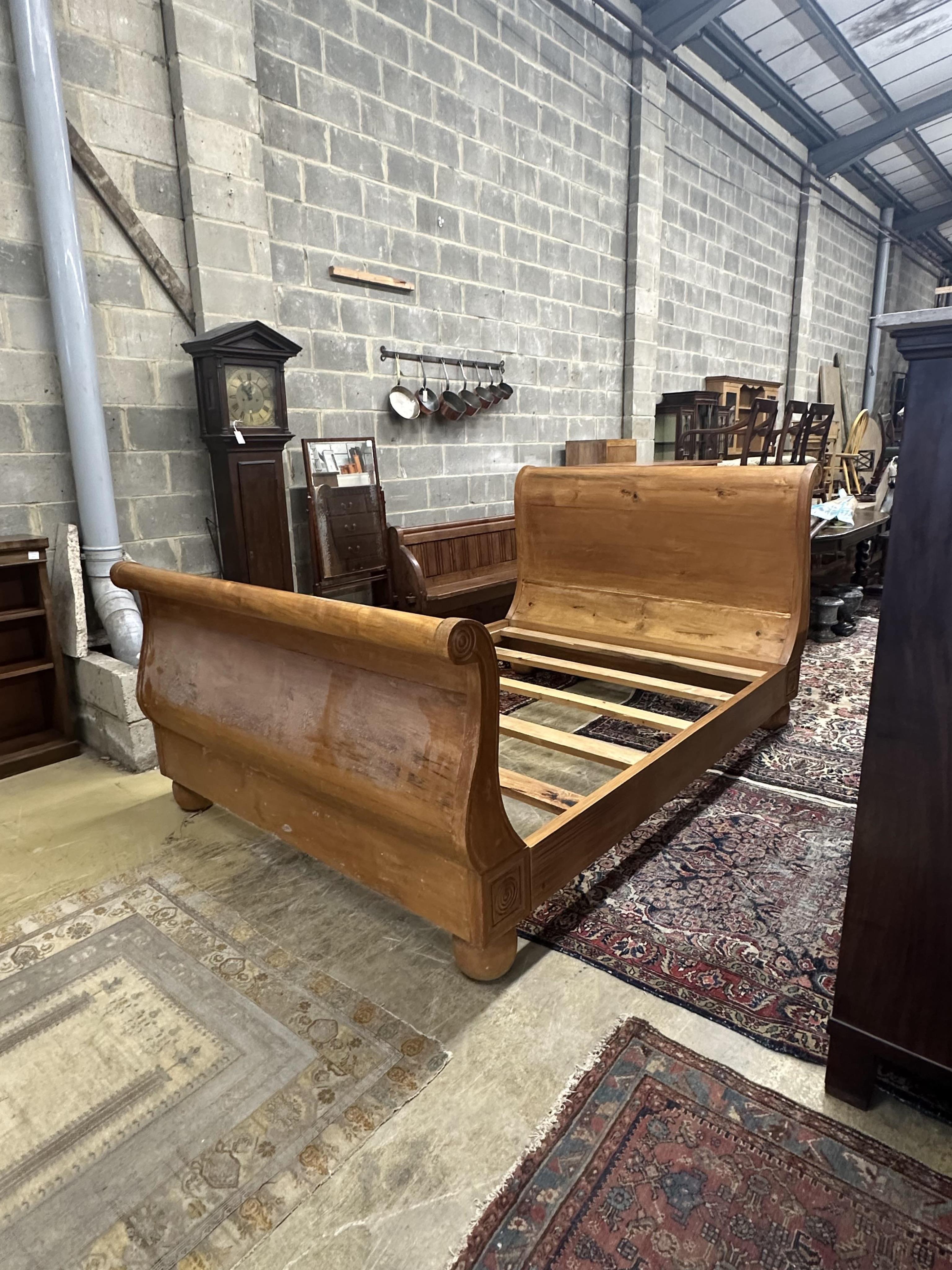 A Continental pine sleigh bed, width 164cm, length 250cm, height 120cm. Condition - poor-fair